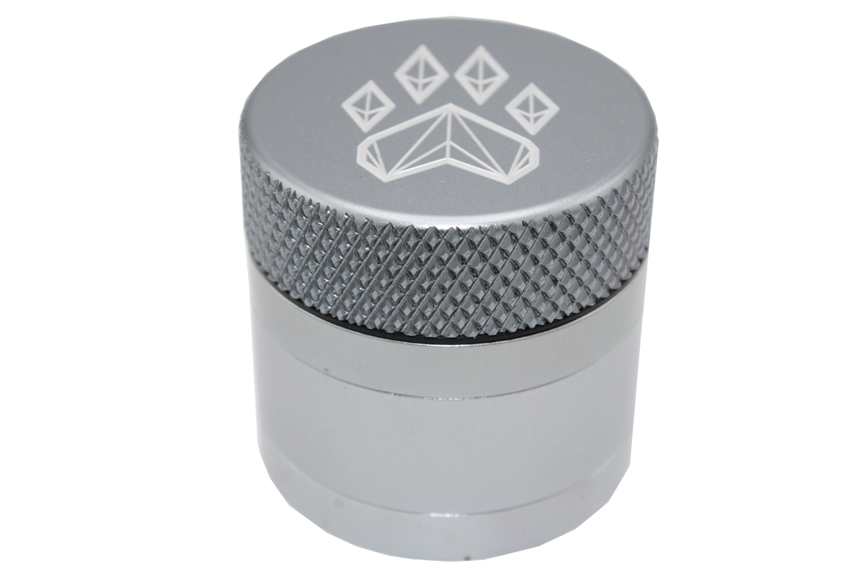 side close up view of the Wolf grinder 1.5" 4 piece grinder. Made of lightweight and durable aluminum. it is precisely made that provides a consistent shred with its sharp teeth while being portable. I ti made in a durable anodized silver coloring.