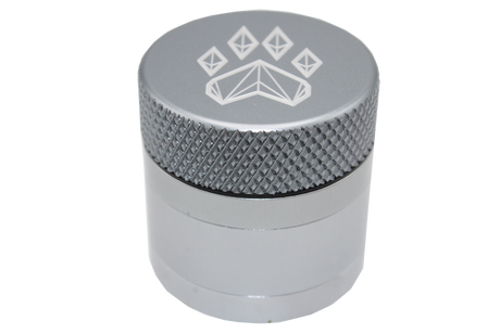 side close up view of the Wolf grinder 1.5" 4 piece grinder. Made of lightweight and durable aluminum. it is precisely made that provides a consistent shred with its sharp teeth while being portable. I ti made in a durable anodized silver coloring.