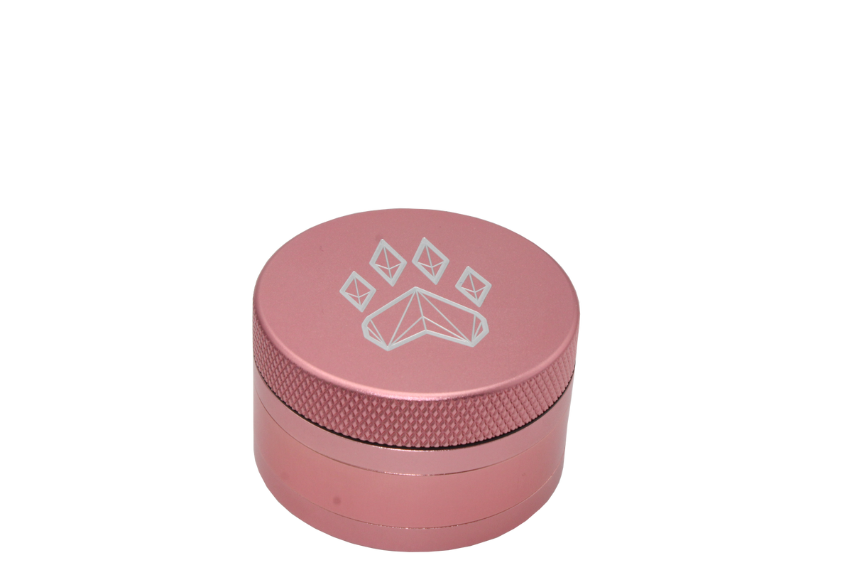 side view of the wolf grinders 2.5" 4 piece metal grinder. made of durable aluminum construction and anodized pink finish for a premium feel.