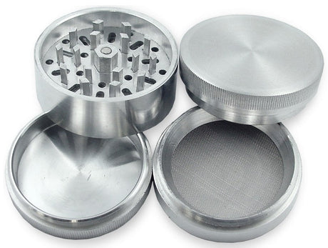 Angled front view of the clear 8-count retail display jar filled with silver 63mm metal grinders. This bulk storage display jar organizes individual 4-piece aluminum herb shredders for easy point-of-sale visibility on smoke shop counters.
