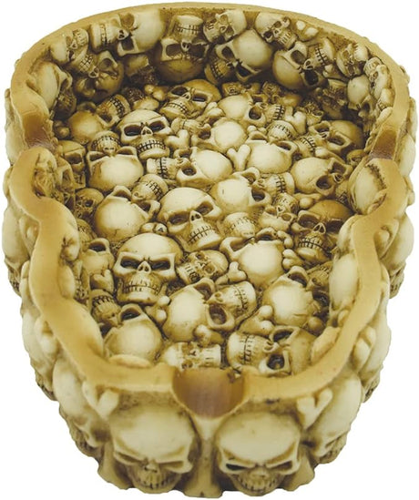Angled profile view of the assorted design metal ashtray featuring a black and white gothic skull graphic. Crafted from heat-resistant tin, the smooth basin is designed to be easily wiped clean after heavy smoking sessions.