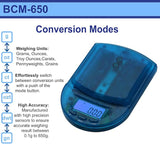 Front angled view of the AWS BCM-650 Measurement Scale in transparent blue. This compact digital pocket scale features a 650g maximum capacity to provide highly accurate, reliable weight readings for loose botanical herbs and solid concentrates.