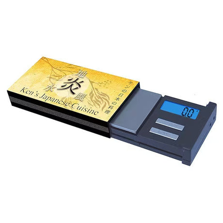 Front angled view of the AWS Matchbox Cuisine digital scale in black with its cover removed. The high-precision 650g x 0.1g stainless steel platform accurately measures herbs, concentrates, and small items on the go.