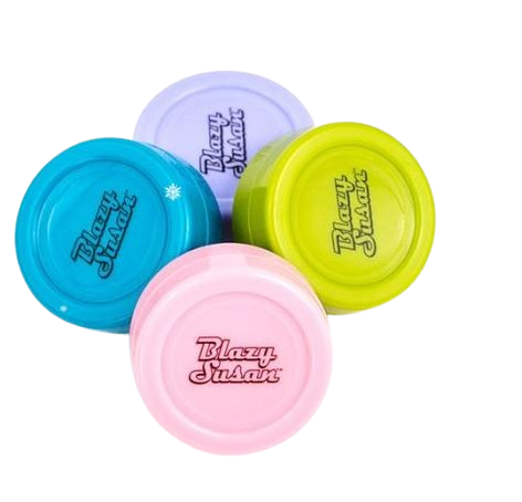 Angled overhead view of the Blazy Susan 32mm silicone dab jar in assorted colors. This durable, non-stick storage container easily safeguards your concentrates while adding a splash of vibrant color to your dabbing setup.
