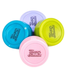 Angled overhead view of the Blazy Susan 32mm silicone dab jar in assorted colors. This durable, non-stick storage container easily safeguards your concentrates while adding a splash of vibrant color to your dabbing setup.