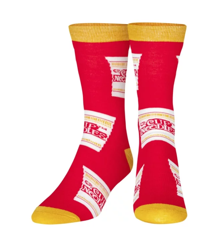 Front view of a pair of Crazy Socks featuring officially licensed Nissin Cup Noodles graphics. These vibrant novelty crew socks showcase the classic red and white cup logo layered over a white and gold background to add a distinct pop to your outfit.
