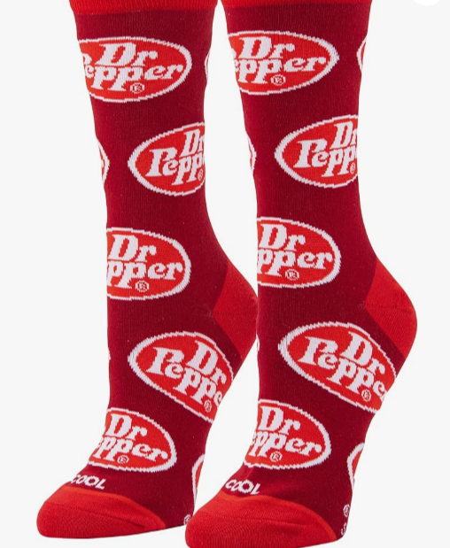 Front view of a pair of Crazy Socks featuring officially licensed Dr Pepper graphics. These vibrant novelty crew socks showcase the classic white brand logo text layered over a rich maroon background to add a distinct pop to your outfit.