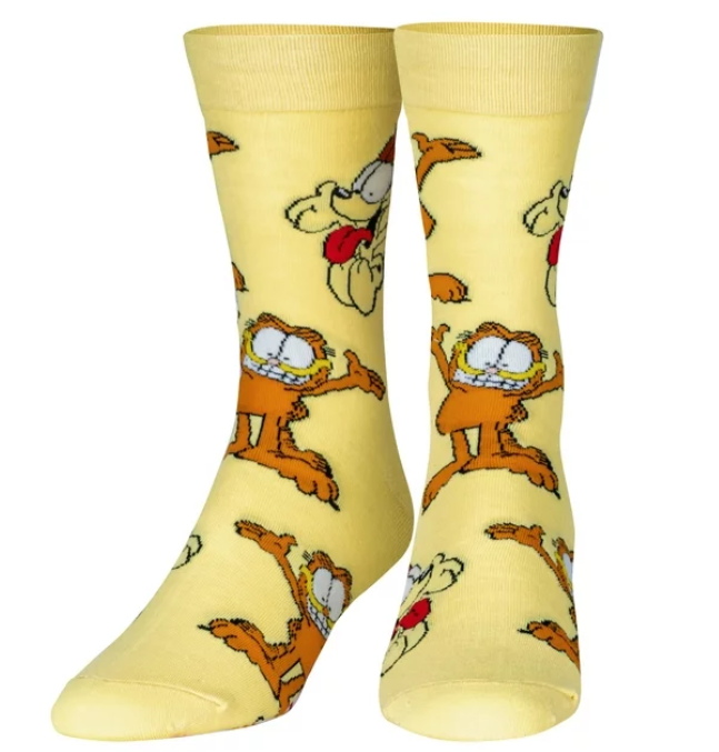 Front view of a pair of Crazy Socks featuring officially licensed Garfield graphics. These vibrant novelty crew socks showcase a repeated pattern of Garfield's classic smirk over a bold orange background to add a playful look to your wardrobe.