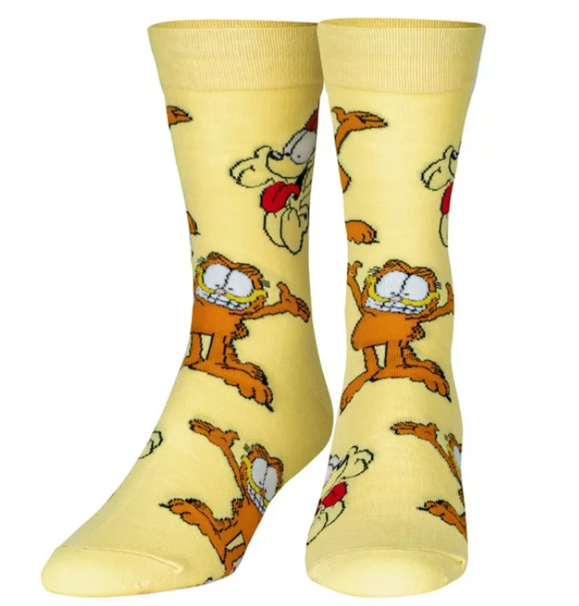 Front view of a pair of Crazy Socks featuring officially licensed Garfield graphics. These vibrant novelty crew socks showcase a repeated pattern of Garfield's classic smirk over a bold orange background to add a playful look to your wardrobe.