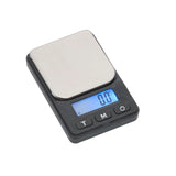 Angled overhead view of the DigiTz DZ1-650 measurement scale in black and silver. This compact 650g pocket scale features a precision stainless steel weighing platform for accurately measuring herbs, jewelry, and small items on the go.