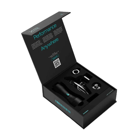 Angled front view of the black Dr. Dabber XS base separated from its clear borosilicate glass filtration attachment. The modular design features a completely spill-proof glass pathway that is easy to fill, drain, and clean.