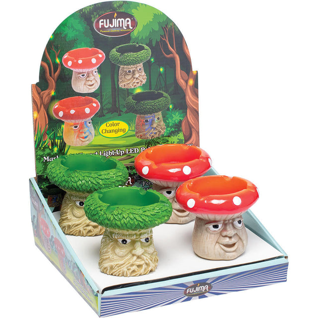 Angled front view of the Fujima Mushroom Forest Light Up LED Polystone Ashtray 4ct wholesale counter display box. This retail-ready package holds four highly detailed, hand-painted resin ashtrays that provide an eye-catching impulse buy for smoke shop shelves.