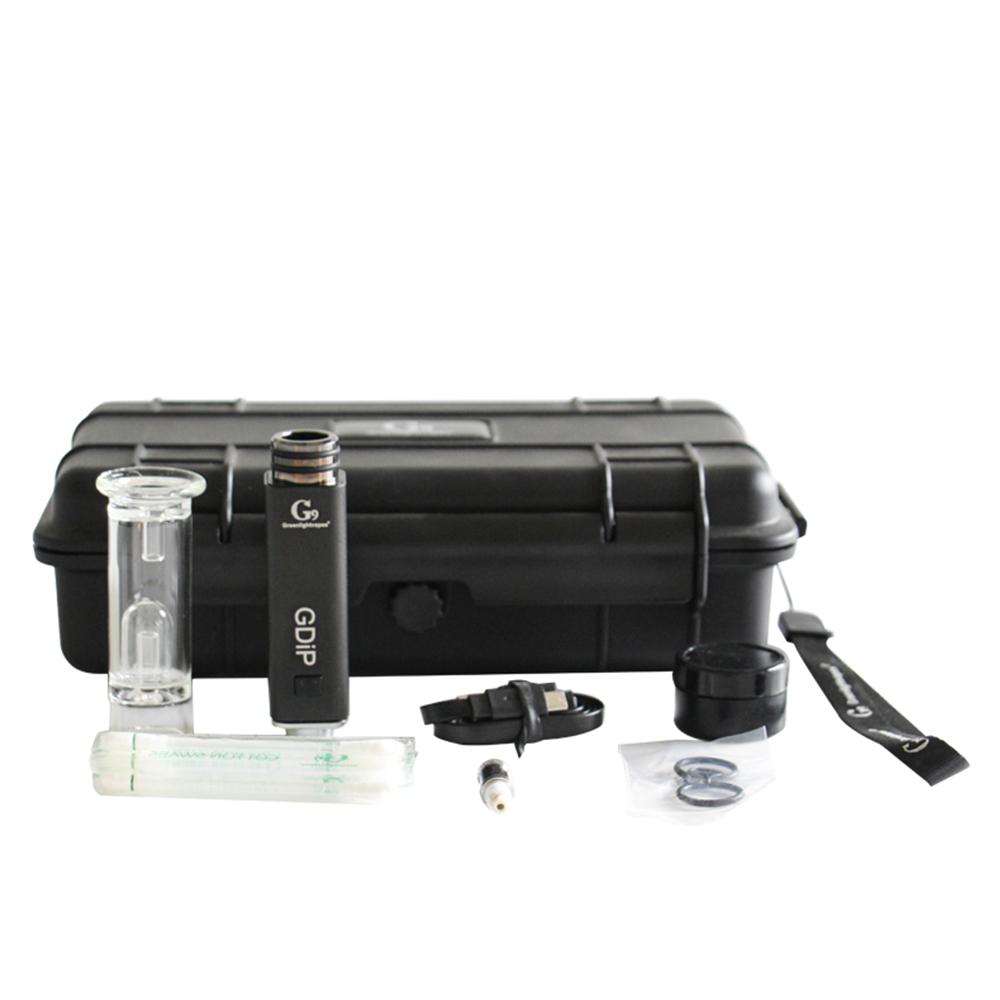 Angled overhead view of the complete G9 Greenlightvapes G-Dip vaporizer kit inside its elegant plastic travel case. This comprehensive dab set includes the device body, two vapor tips, glass bubbler, cleaning swab, silicone container, and a micro-USB charging cable.