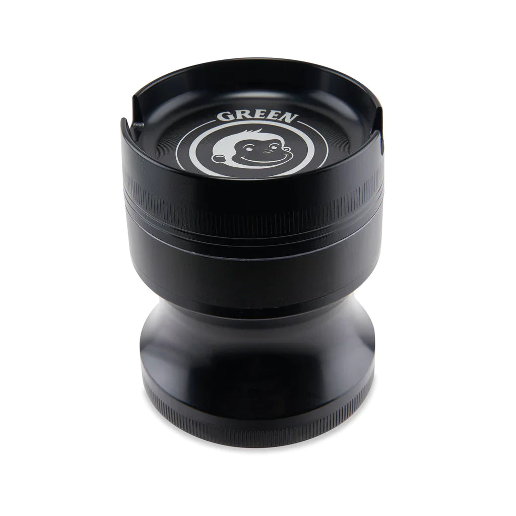 Angled view of the Green Monkey Chacma grinder in deep purple. This durable 63mm 4-piece zinc alloy grinder features a chalice-style shape and a built-in ashtray on the lid for convenience.