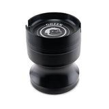 Angled view of the Green Monkey Chacma grinder in deep purple. This durable 63mm 4-piece zinc alloy grinder features a chalice-style shape and a built-in ashtray on the lid for convenience.