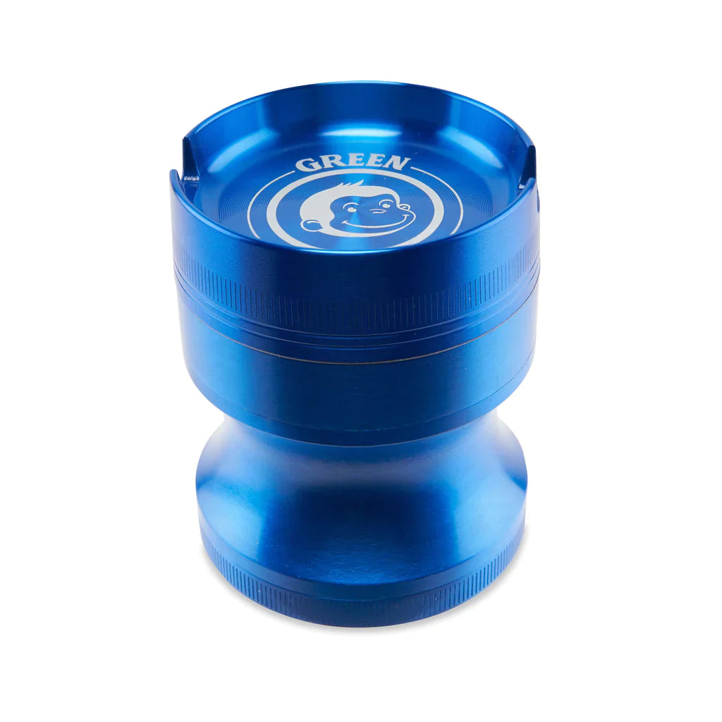 Angled view of the Green Monkey Chacma grinder in metallic blue. This durable 63mm 4-piece zinc alloy grinder features a chalice-style shape and a built-in ashtray on the lid for convenience.