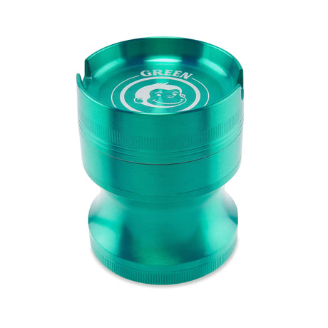 Angled view of the Green Monkey Chacma grinder in bright green. This durable 63mm 4-piece zinc alloy grinder features a chalice-style shape and a built-in ashtray on the lid for convenience.