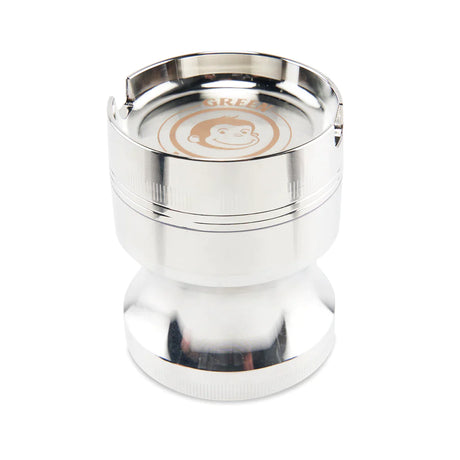 Angled view of the Green Monkey Chacma grinder in sleek silver. This durable 63mm 4-piece zinc alloy grinder features a chalice-style shape and a built-in ashtray on the lid for convenience.