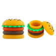 Angled overhead view of the Hamburger silicone wax containers in brown, green, yellow, and red. These 5ml food-themed, residue-repellent extract carriers feature removable modular rings and securely store semi-solid botanical materials.