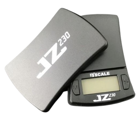 Angled overhead view of the Jennings JZ230 scale in black and silver, shown open. This pocket-sized digital scale features a protective cover that doubles as an expansion tray for accurately measuring dry herbs and concentrates.