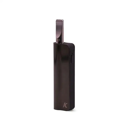 Side profile view of the Kandypens C-Box Mini battery in stealth black with a standard glass oil cartridge inserted. Operating via an intuitive auto-draw activation mechanism, this highly portable 390mAh device is perfectly sized to fit securely in the palm of your hand.