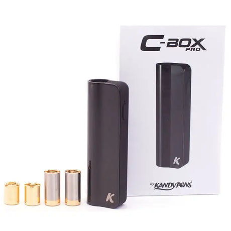 Angled overhead view of the complete Kandypens C-Box Mini battery kit in stealth black laid out against a clean white background. This premium concealed vaporizer starter set includes the 390mAh battery base, two magnetic 510-thread adapters, and a fast-charging micro-USB cable.