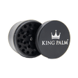 Front view of the King Palm 62mm aluminum herb grinder in sleek matte black. This premium 4-piece metal grinder features a strong magnetic lid and sharp diamond-shaped teeth to effortlessly shred dry herbs for your palm leaf rolls.