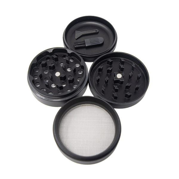 Angled overhead view of the King Palm 62mm aluminum herb grinder in black, disassembled to show its four-piece construction. This highly durable accessory includes a dedicated grinding chamber, a deep flower storage catch, and a fine mesh pollen screen.