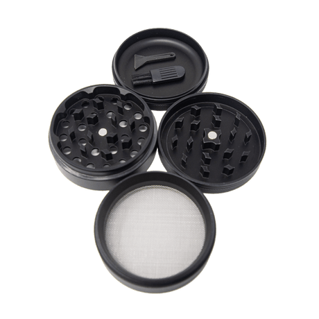 Angled overhead view of the King Palm 62mm aluminum herb grinder in black, disassembled to show its four-piece construction. This highly durable accessory includes a dedicated grinding chamber, a deep flower storage catch, and a fine mesh pollen screen.
