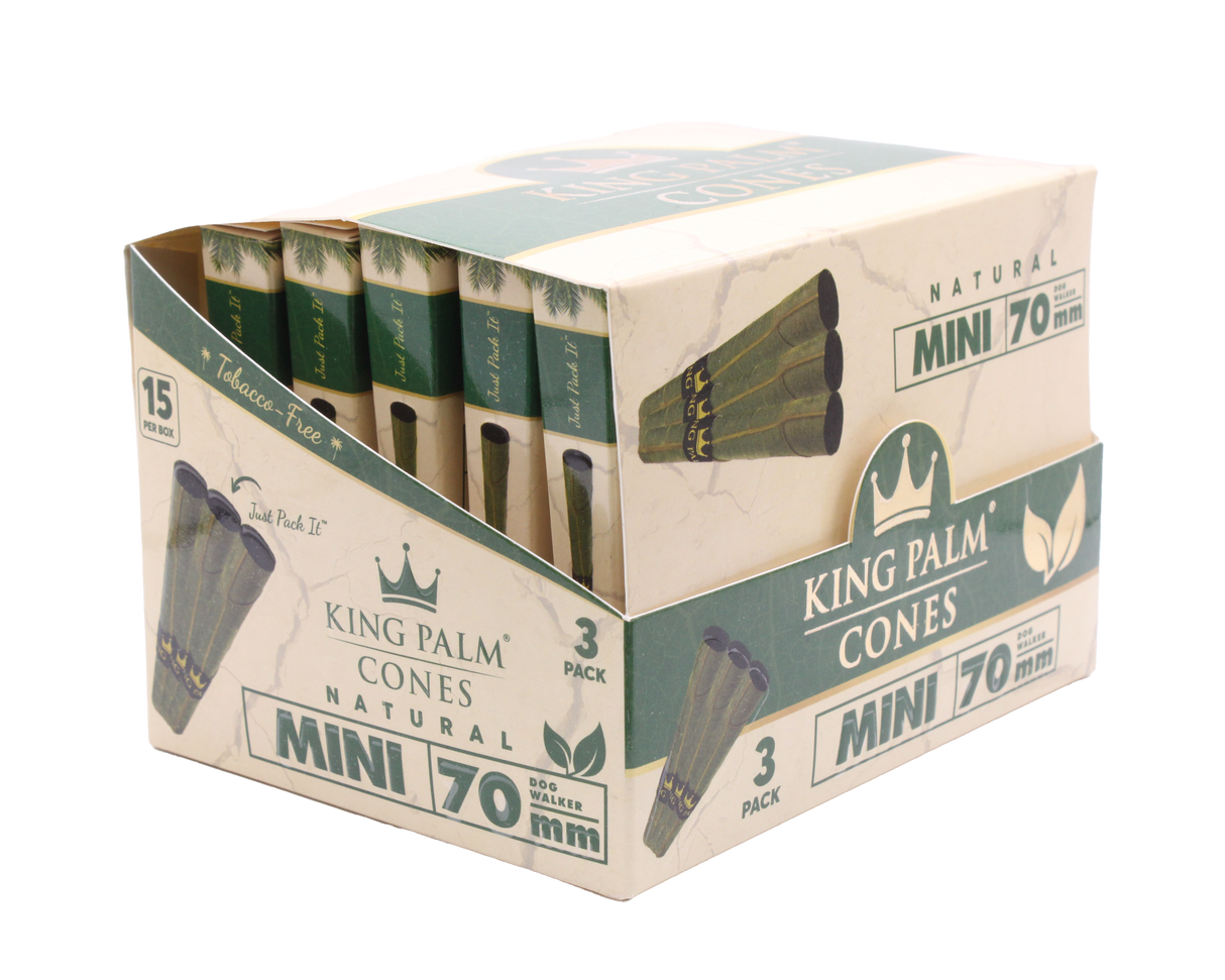 Angled overhead view of the open King Palm mini display box. The black and green wholesale carton houses fifteen individual foil pouches precisely formatted for rapid retail turnover.