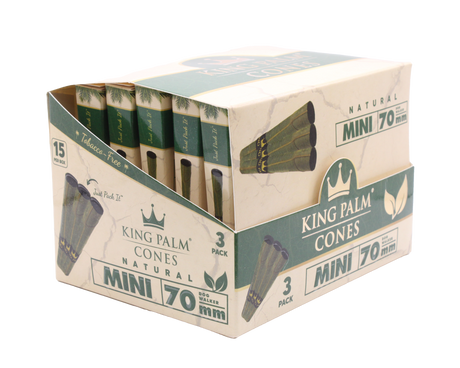 Angled overhead view of the open King Palm mini display box. The black and green wholesale carton houses fifteen individual foil pouches precisely formatted for rapid retail turnover.