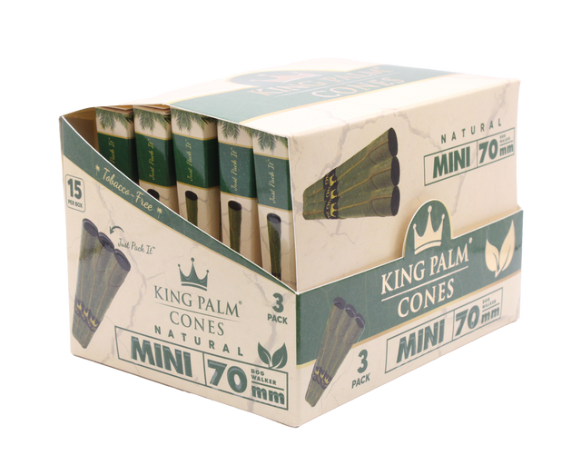 Angled overhead view of the open King Palm mini display box. The black and green wholesale carton houses fifteen individual foil pouches precisely formatted for rapid retail turnover.