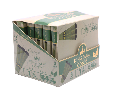 Angled overhead view of the open King Palm mini display box. The black and green wholesale carton houses fifteen individual foil pouches precisely formatted for rapid retail turnover.