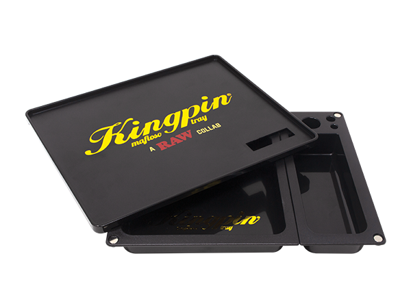 Angled overhead view of the Kingpin x RAW Mafioso tray showing the magnetic top cover partially lifted. Designed as a clever pass-through screen, this upper layer lets you break down dry herbs on top and effortlessly push them into the storage basins below.