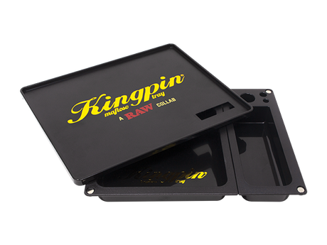 Angled overhead view of the Kingpin x RAW Mafioso tray showing the magnetic top cover partially lifted. Designed as a clever pass-through screen, this upper layer lets you break down dry herbs on top and effortlessly push them into the storage basins below.