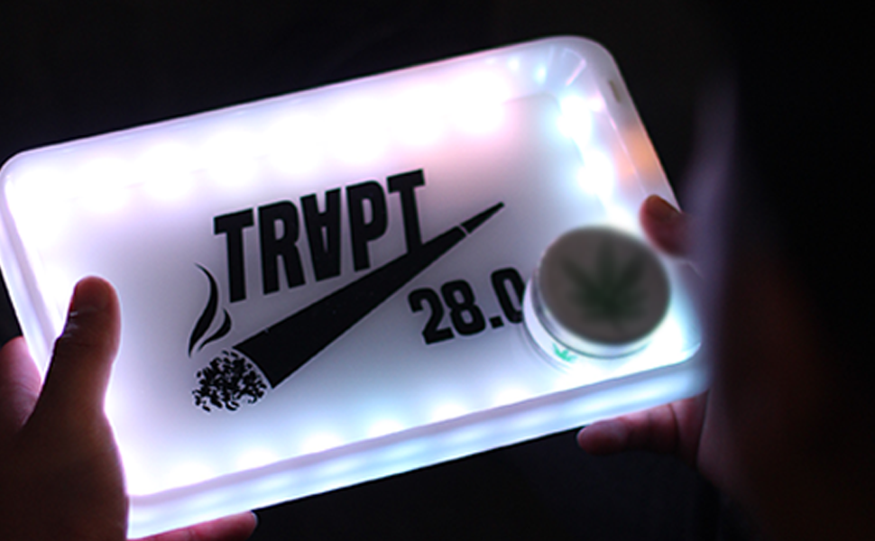Front view of the medium LED rolling trays showcasing a variety of assorted colorful street graphic designs. This highly functional, illuminated prep surface features a raised rim to securely keep your dry herbs contained while rolling.
