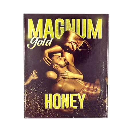 Angled overhead view of the Magnum Gold Honey retail display box featuring matching gold and black artwork. This professional wholesale countertop display container holds multiple individual honey sachets for convenient presentation and dispensing in retail environments.