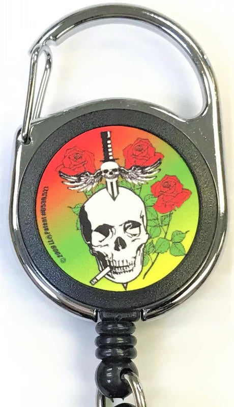 Front facing view of the Merchants Lighter Leash Tattoo Series Holder displaying an assortment of roses with a skull and knife with wings. This highly practical retail companion accessory clips securely to belt loops, keys, or pockets to ensure consumers never lose their lighter.