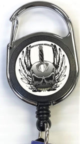 Front facing view of the Merchants Lighter Leash Tattoo Series Holder displaying a skull with wings and sword. This highly practical retail companion accessory clips securely to belt loops, keys, or pockets to ensure consumers never lose their lighter.