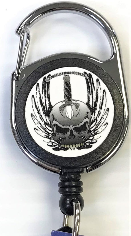 Front facing view of the Merchants Lighter Leash Tattoo Series Holder displaying a skull with wings and sword. This highly practical retail companion accessory clips securely to belt loops, keys, or pockets to ensure consumers never lose their lighter.