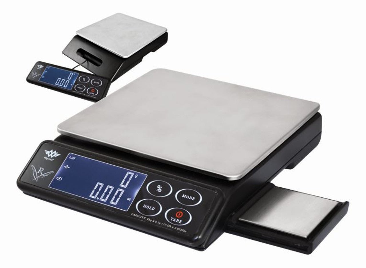 Front angled view of the My Weigh Maestro dual platform scale in matte black with two silver stainless steel weighing surfaces. This professional 2-in-1 culinary scale allows bakers to measure heavy bulk ingredients and micro-precision additives simultaneously.