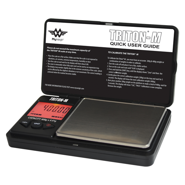 Angled overhead view of the My Weigh Triton T2 digital mini scale in black. This compact 400g x 0.01g pocket scale features a durable ribbed outer casing for precise, everyday weighing of herbs, concentrates, and small jewelry.