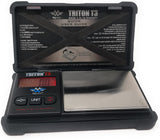 Angled overhead view of the My Weigh Triton T3 digital scale in black with a rugged rubber outer case. This highly durable 660g x 0.1g pocket scale features a heavy-duty, impact-resistant design perfect for everyday on-the-go weighing.