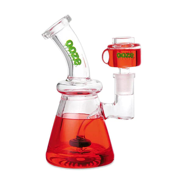 Front view of the Ooze Glyco Glycerin Freezable Water Pipe in scarlet. This compact 6.5-inch borosilicate glass beaker bong features a hollow base filled with bright green freezable liquid glycerin to deliver incredibly cold, ice-like hits.
