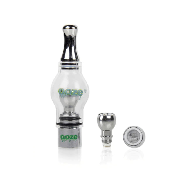 Angled overhead view of the complete Ooze Gusher Globe vaporizer kit laid out against a clean white background. This all-inclusive concentrate starter set features the 650mAh rechargeable battery, hand-blown glass globe, dual quartz heating coils, a stainless steel dab tool, and a USB charging cable.