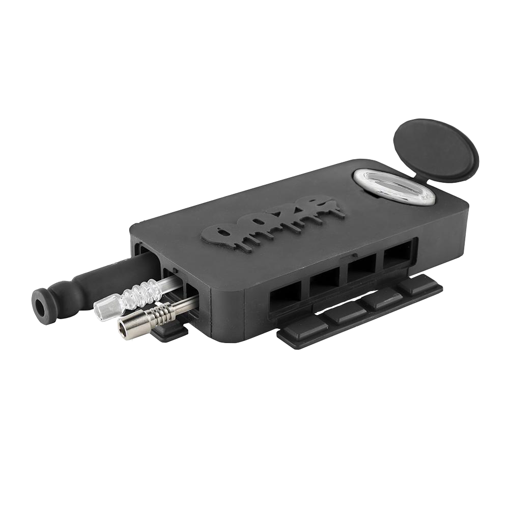 Front angled view of the Ooze Slugger Dugout Travel Kit in sleek black. This pocket-sized silicone travel piece neatly contains all your necessary concentrate accessories inside an impact-resistant, discreetly flat block.