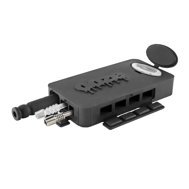 Front angled view of the Ooze Slugger Dugout Travel Kit in sleek black. This pocket-sized silicone travel piece neatly contains all your necessary concentrate accessories inside an impact-resistant, discreetly flat block.