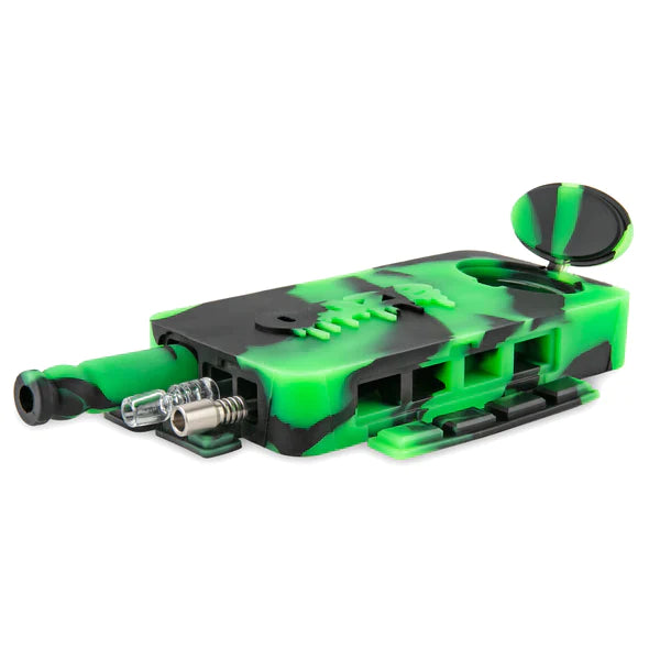 Front angled view of the Ooze Slugger Dugout Travel Kit in sleek black green. This pocket-sized silicone travel piece neatly contains all your necessary concentrate accessories inside an impact-resistant, discreetly flat block.
