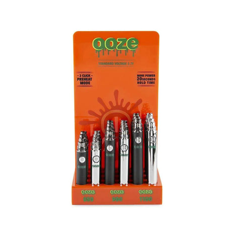 Front view of the Ooze standard 510 battery 24-count acrylic display filled with assorted metallic and solid colors. This retail-ready wholesale stand provides smoke shops with highly reliable, easy-to-use vape batteries perfectly sized for checkout counters.