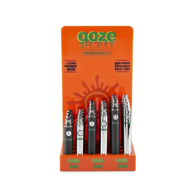 Front view of the Ooze standard 510 battery 24-count acrylic display filled with assorted metallic and solid colors. This retail-ready wholesale stand provides smoke shops with highly reliable, easy-to-use vape batteries perfectly sized for checkout counters.
